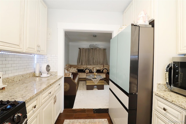 7524 Williamson St, Dearborn, MI 48126 - kitchen with stainless steel appliances, light stone counters, tasteful backsplash, and dark wood-style flooring