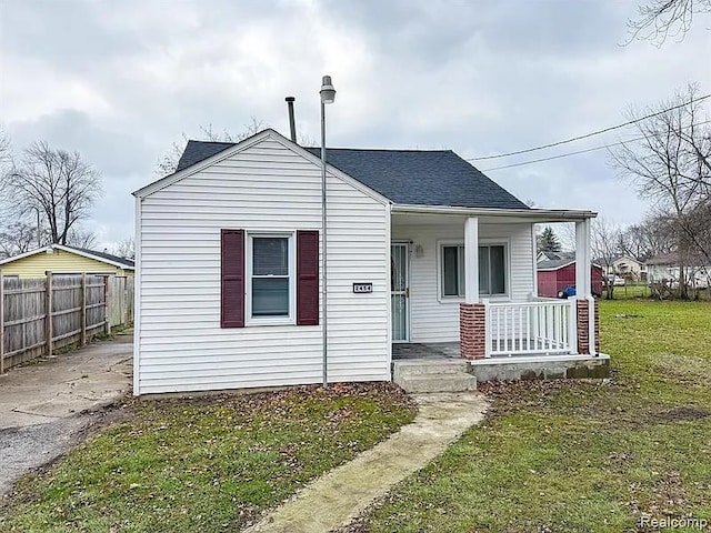 2454 Bellevue St, Saginaw, MI 48601 - bungalow with a porch and a shingled roof