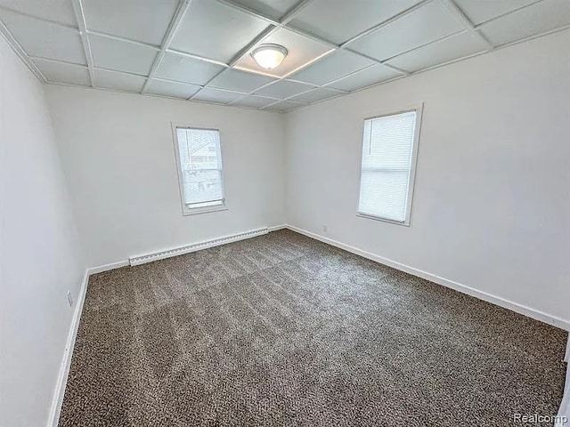 2454 Bellevue St, Saginaw, MI 48601 - empty room with dark colored carpet, baseboards, and a baseboard heating unit