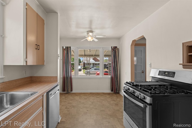 13522 Callender St, Southgate, MI 48195 - kitchen with appliances with stainless steel finishes, ceiling fan, light countertops, and arched walkways