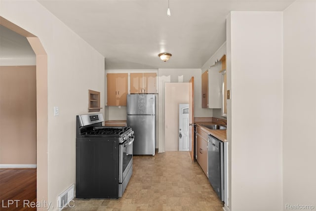 13522 Callender St, Southgate, MI 48195 - kitchen with appliances with stainless steel finishes, arched walkways, and light countertops