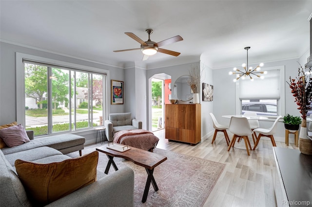 23069 Violet St, Farmington, MI 48336 - living room with a chandelier, arched walkways, ornamental molding, ceiling fan, and light wood-type flooring