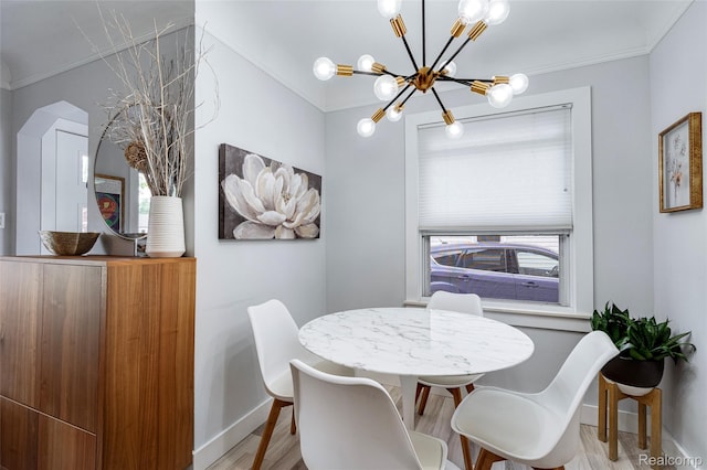 23069 Violet St, Farmington, MI 48336 - dining space featuring a chandelier, crown molding, and wood finished floors