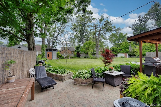 23069 Violet St, Farmington, MI 48336 - fenced backyard with a patio, a grill, and a storage unit