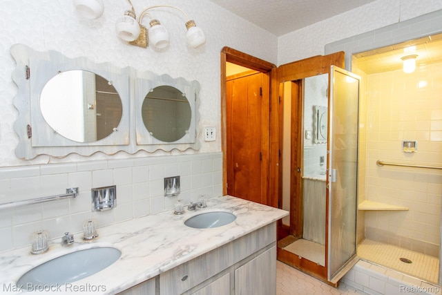 25695 York Rd, Royal Oak, MI 48067 - bathroom with double vanity, a shower stall, wallpapered walls, tile patterned flooring, and tile walls