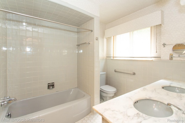 25695 York Rd, Royal Oak, MI 48067 - bathroom featuring  shower combination, tile walls, tile patterned flooring, and double vanity