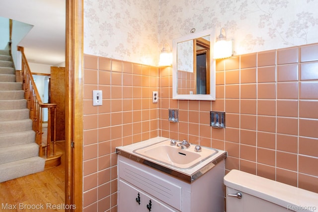 25695 York Rd, Royal Oak, MI 48067 - half bathroom with wallpapered walls, tile walls, and vanity