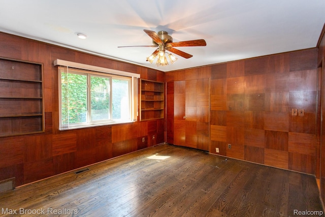 25695 York Rd, Royal Oak, MI 48067 - empty room with wood walls, built in features, a ceiling fan, and wood finished floors