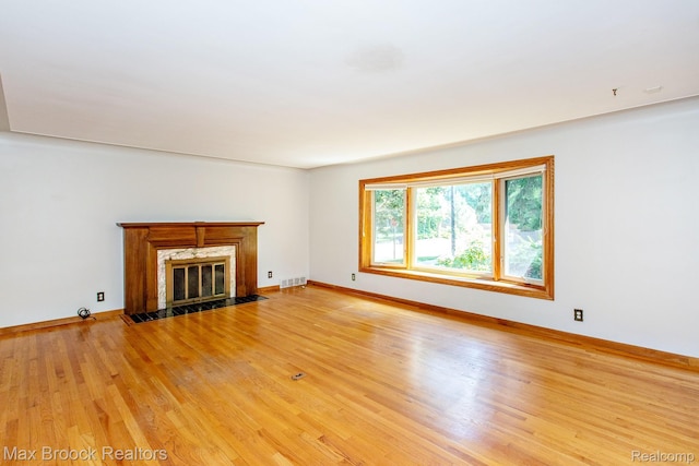 25695 York Rd, Royal Oak, MI 48067 - unfurnished living room with a premium fireplace and light wood-style flooring