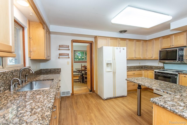 25695 York Rd, Royal Oak, MI 48067 - kitchen featuring white refrigerator with ice dispenser, electric range oven, light brown cabinetry, stone counters, and light wood-style floors