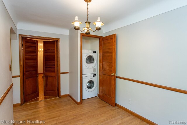 25695 York Rd, Royal Oak, MI 48067 - laundry room featuring stacked washing machine and dryer, a chandelier, and light wood finished floors