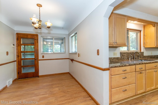 25695 York Rd, Royal Oak, MI 48067 - kitchen featuring a chandelier, light wood-style flooring, plenty of natural light, and dark stone countertops