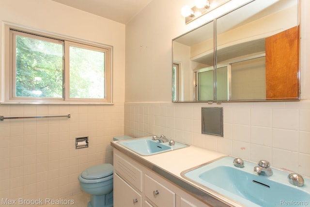 25695 York Rd, Royal Oak, MI 48067 - bathroom with plenty of natural light, tile walls, a shower with shower door, and double vanity