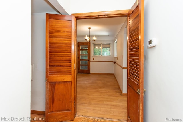 25695 York Rd, Royal Oak, MI 48067 - corridor with light wood-style floors and a chandelier