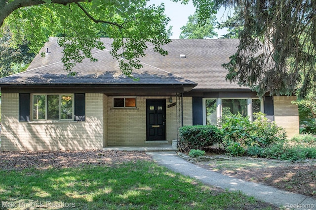 25695 York Rd, Royal Oak, MI 48067 - view of front of house featuring brick siding, a shingled roof, and covered porch