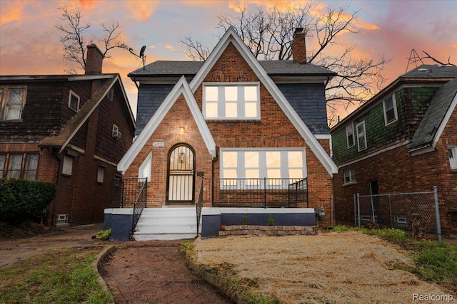 16525 Roselawn St, Detroit, MI 48221 - tudor-style house featuring brick siding, a chimney, and roof with shingles