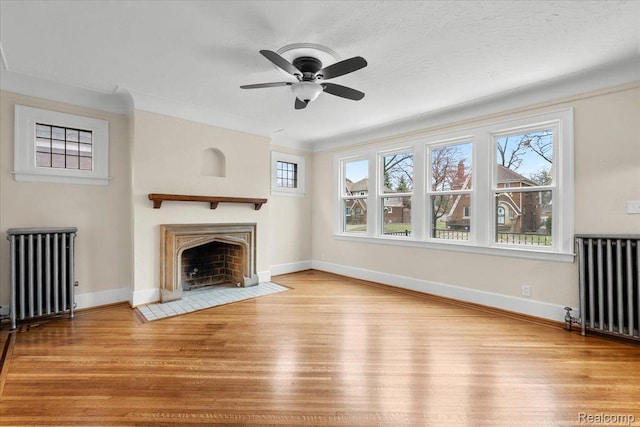 16525 Roselawn St, Detroit, MI 48221 - unfurnished living room with radiator heating unit, wood finished floors, ceiling fan, and crown molding