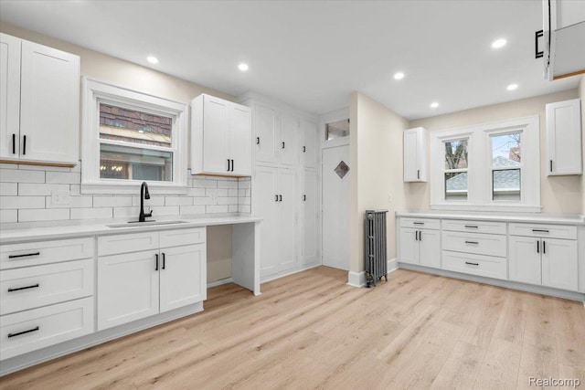 16525 Roselawn St, Detroit, MI 48221 - kitchen featuring a sink, light wood-type flooring, tasteful backsplash, white cabinetry, and recessed lighting