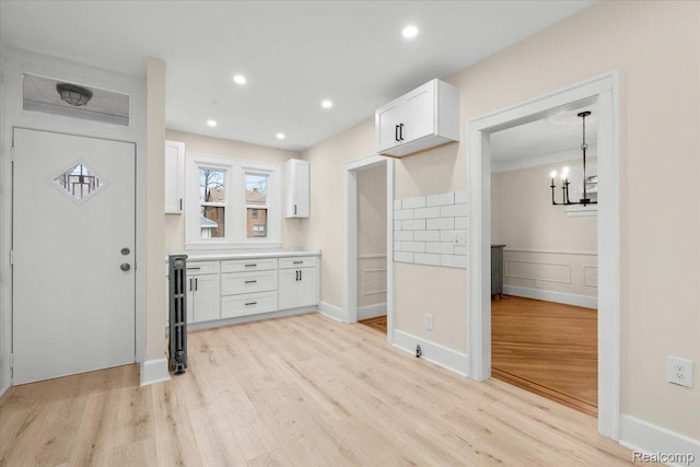 16525 Roselawn St, Detroit, MI 48221 - foyer with light wood-style flooring, a chandelier, recessed lighting, and wainscoting