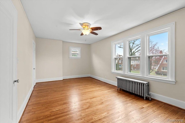 16525 Roselawn St, Detroit, MI 48221 - spare room featuring radiator heating unit, light wood finished floors, ceiling fan, and baseboards