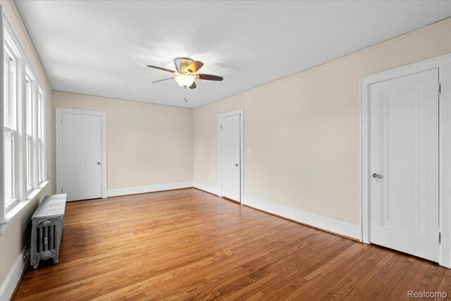 16525 Roselawn St, Detroit, MI 48221 - empty room featuring a ceiling fan, light wood-style flooring, plenty of natural light, and baseboards