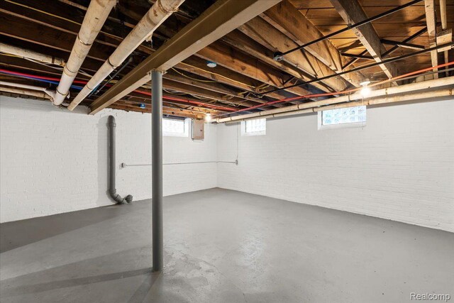 16525 Roselawn St, Detroit, MI 48221 - basement featuring brick wall, electric panel, and healthy amount of natural light