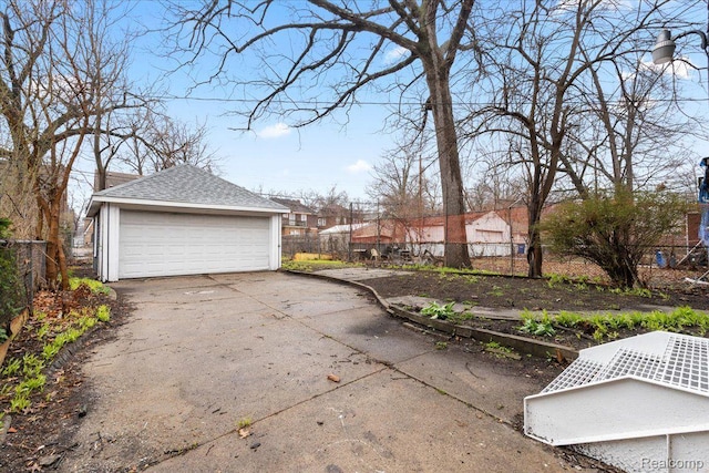 16525 Roselawn St, Detroit, MI 48221 - view of home's exterior featuring a detached garage, an outdoor structure, and a shingled roof