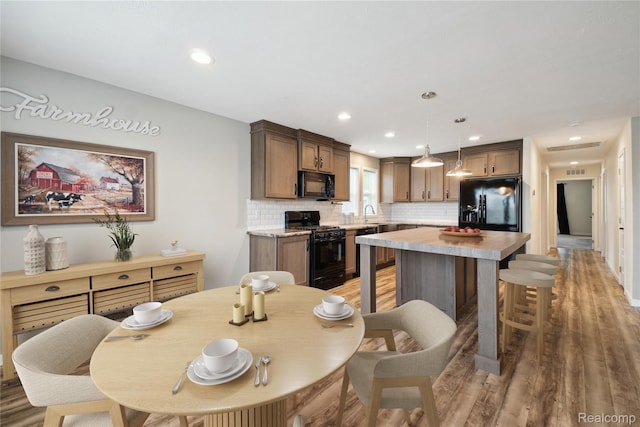 6464 Prince, Fenton, MI 48430 - dining room featuring light wood-type flooring and recessed lighting