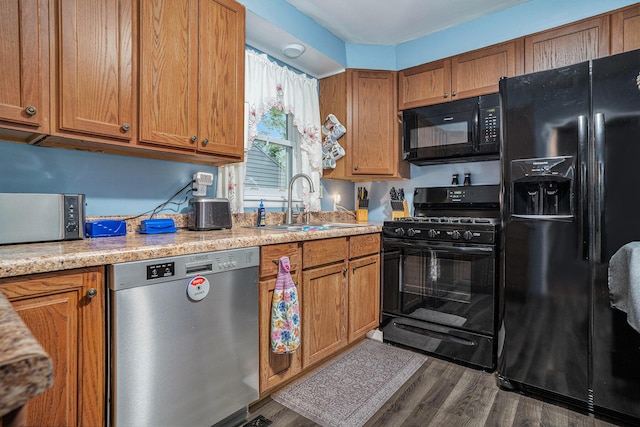 1370 Langeland Ave, Muskegon, MI 49442 - kitchen with black appliances, light countertops, brown cabinets, dark wood finished floors, and a sink