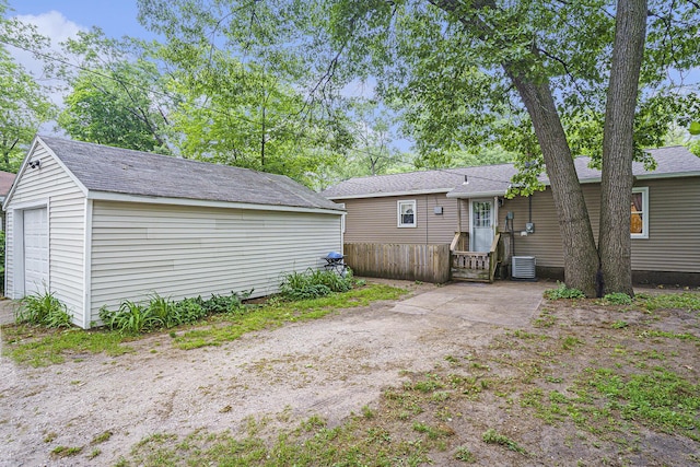 1370 Langeland Ave, Muskegon, MI 49442 - back of house with an outbuilding, central AC unit, and roof with shingles