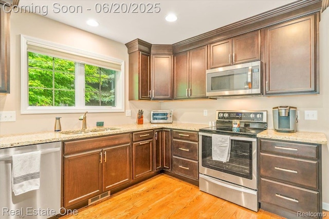 43543 Abbey Cir, Canton, MI 48187 - kitchen featuring stainless steel appliances, light wood-style floors, light stone counters, and recessed lighting