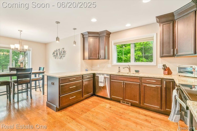 43543 Abbey Cir, Canton, MI 48187 - kitchen with stainless steel appliances, a peninsula, light wood-type flooring, a chandelier, and hanging light fixtures
