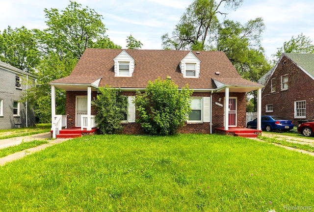 12702-12710 Kelly Rd, Detroit, MI 48224 - cape cod-style house with brick siding, a front yard, and roof with shingles