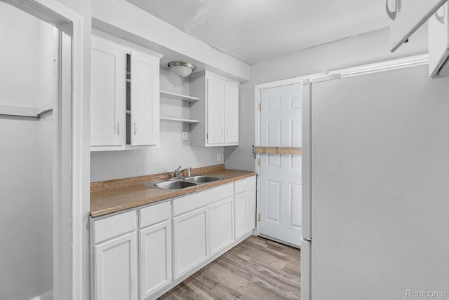 12702-12710 Kelly Rd, Detroit, MI 48224 - kitchen featuring freestanding refrigerator, open shelves, white cabinets, and light wood-type flooring