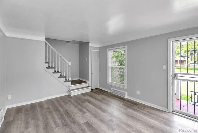 12702-12710 Kelly Rd, Detroit, MI 48224 - unfurnished living room featuring plenty of natural light, wood finished floors, and stairs
