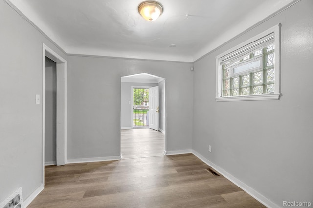 12702-12710 Kelly Rd, Detroit, MI 48224 - empty room with arched walkways and wood finished floors