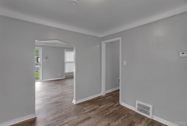 12702-12710 Kelly Rd, Detroit, MI 48224 - spare room with arched walkways and wood finished floors