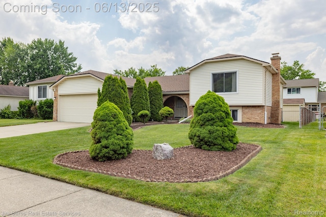 47425 Barbara Rd, Macomb, MI 48044 - split level home with concrete driveway, brick siding, a garage, a front yard, and a chimney