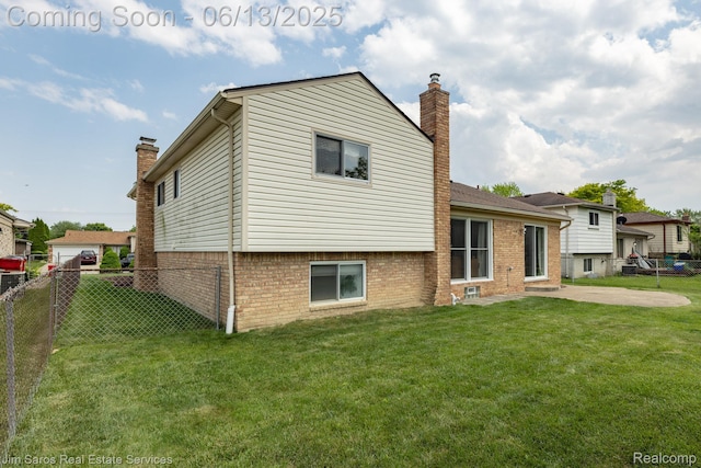 47425 Barbara Rd, Macomb, MI 48044 - back of house with a chimney, a patio, and brick siding