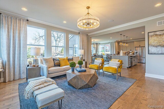 16245 Rogan Dr, Linden, MI 48451 - living area with a chandelier, ornamental molding, recessed lighting, light wood-type flooring, and baseboards