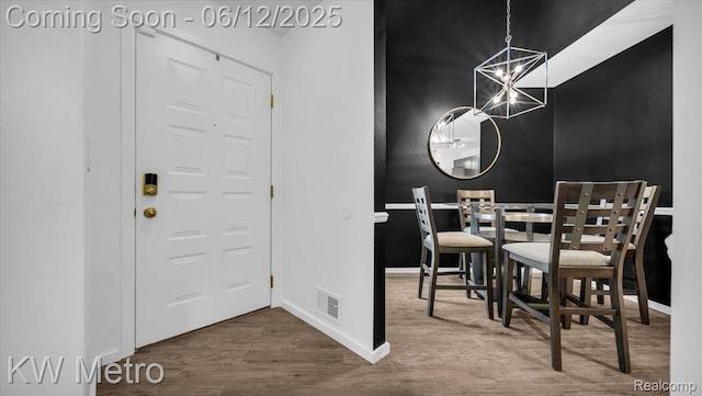 4013 Foxpointe Dr, West Bloomfield, MI 48323 - dining space with a chandelier, wood finished floors, and baseboards