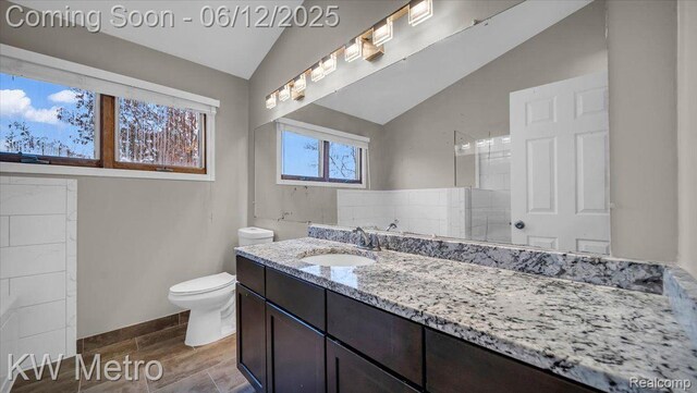 4013 Foxpointe Dr, West Bloomfield, MI 48323 - bathroom featuring vaulted ceiling, toilet, vanity, and baseboards
