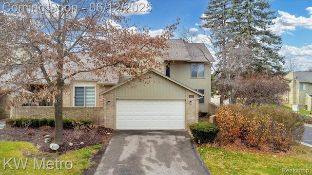 4013 Foxpointe Dr, West Bloomfield, MI 48323 - view of front of home with driveway, a garage, and brick siding