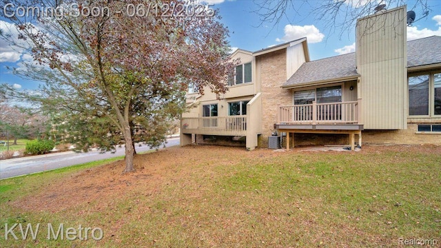 4013 Foxpointe Dr, West Bloomfield, MI 48323 - back of property with central AC unit, a yard, and a shingled roof