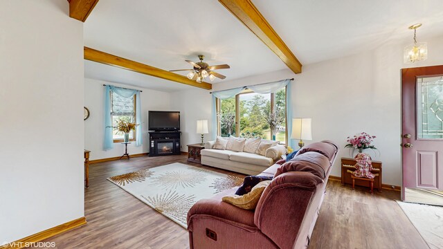 16486 Three Oaks Rd, Three Oaks, MI 49128 - living area featuring healthy amount of natural light, beam ceiling, a ceiling fan, baseboards, and wood finished floors