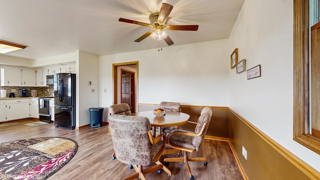 16486 Three Oaks Rd, Three Oaks, MI 49128 - dining area featuring wood finished floors, ceiling fan, and baseboards