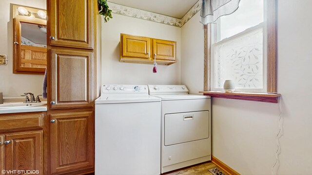 16486 Three Oaks Rd, Three Oaks, MI 49128 - laundry area featuring cabinet space and independent washer and dryer