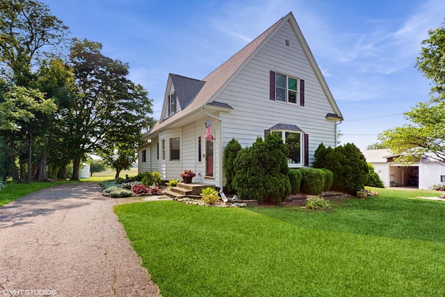 16486 Three Oaks Rd, Three Oaks, MI 49128 - view of front of property with a front yard, roof with shingles, and asphalt driveway