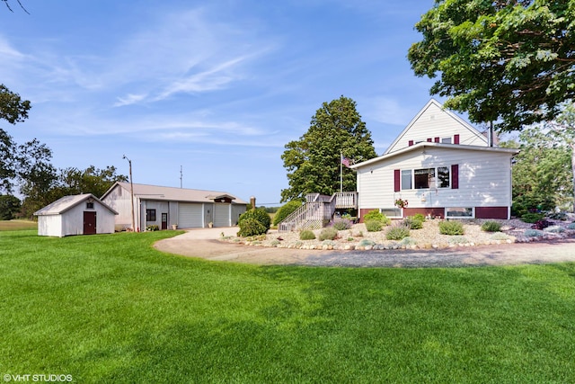 16486 Three Oaks Rd, Three Oaks, MI 49128 - back of house with stairway, a yard, and a garage