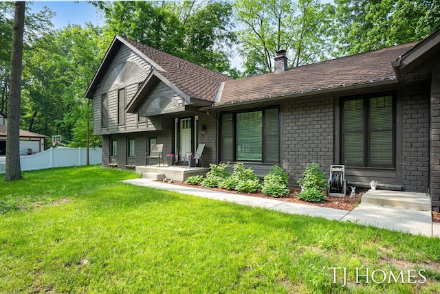 2605 Shadowbrook Dr SE, Grand Rapids, MI 49546 - view of front facade with a chimney and brick siding